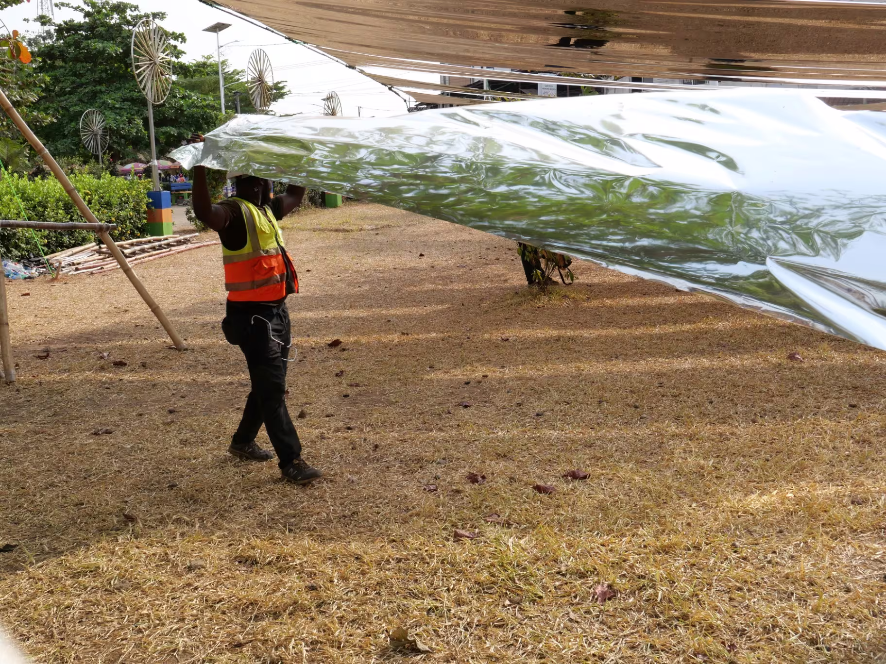 Carrying a length of reflective sheeting under a canopy