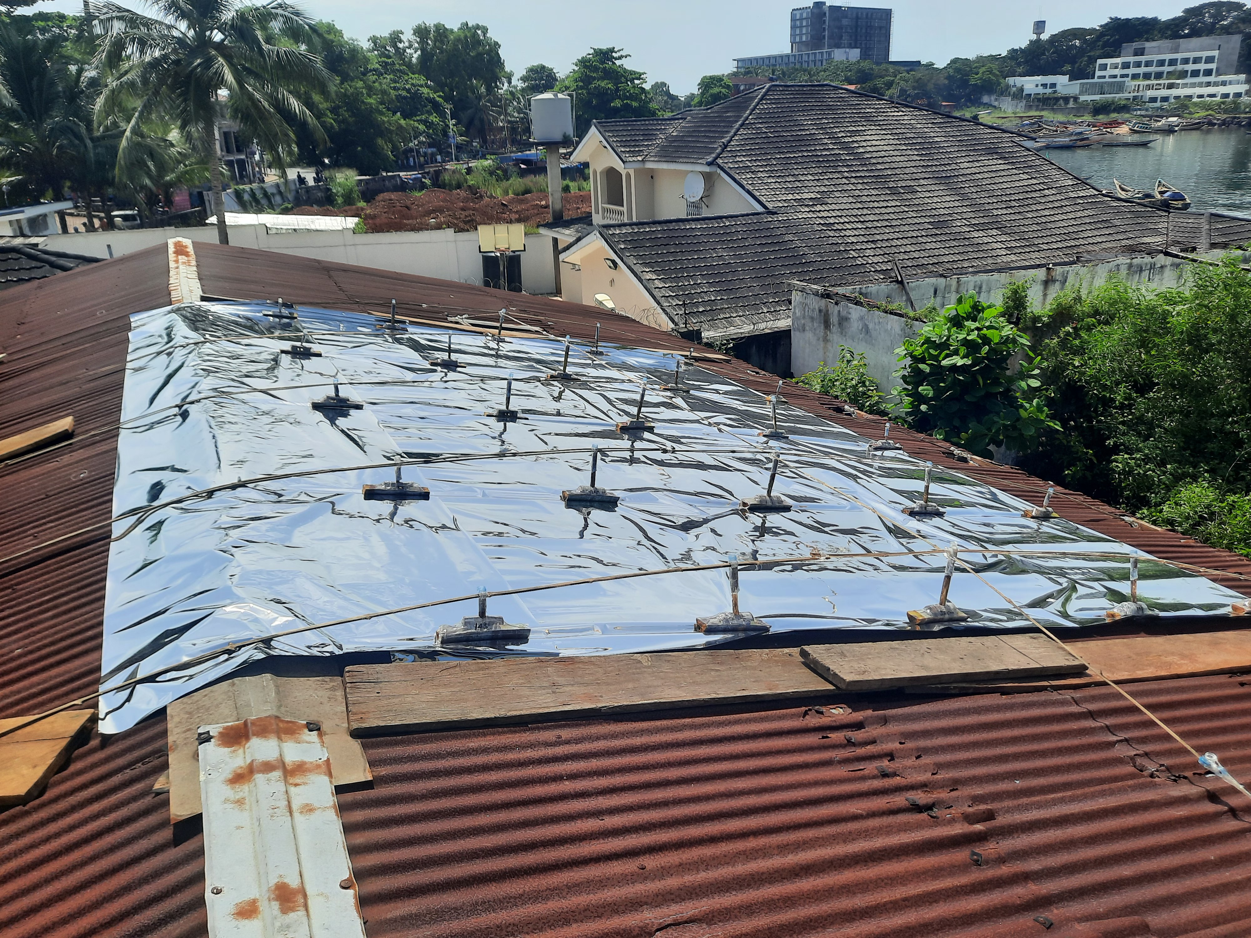 The clamp-based reflective roof system — non-penetrative, protecting existing tin roofs.