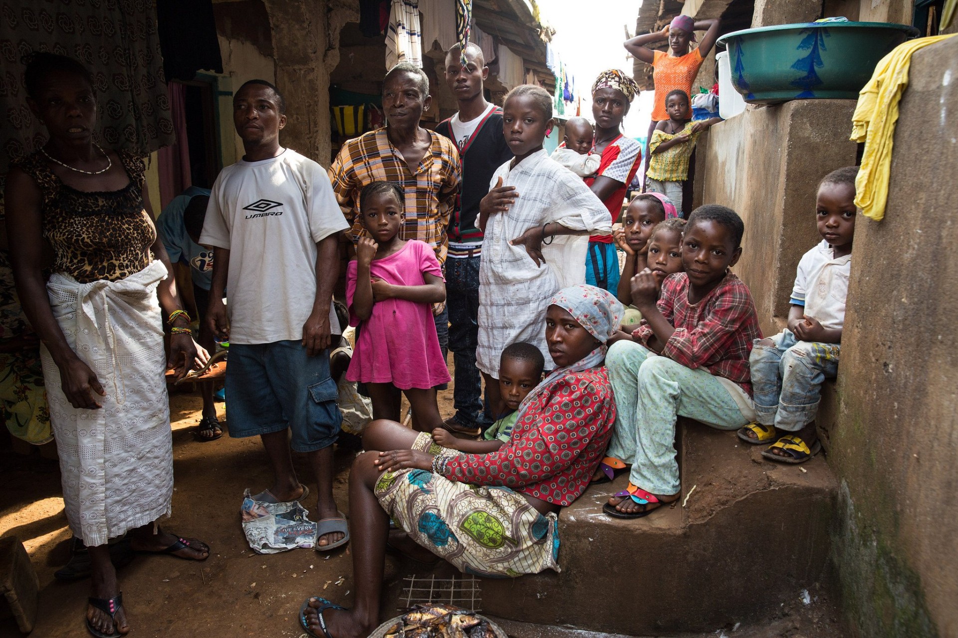 Residents gathered in a narrow lane in Kroo Bay, Freetown