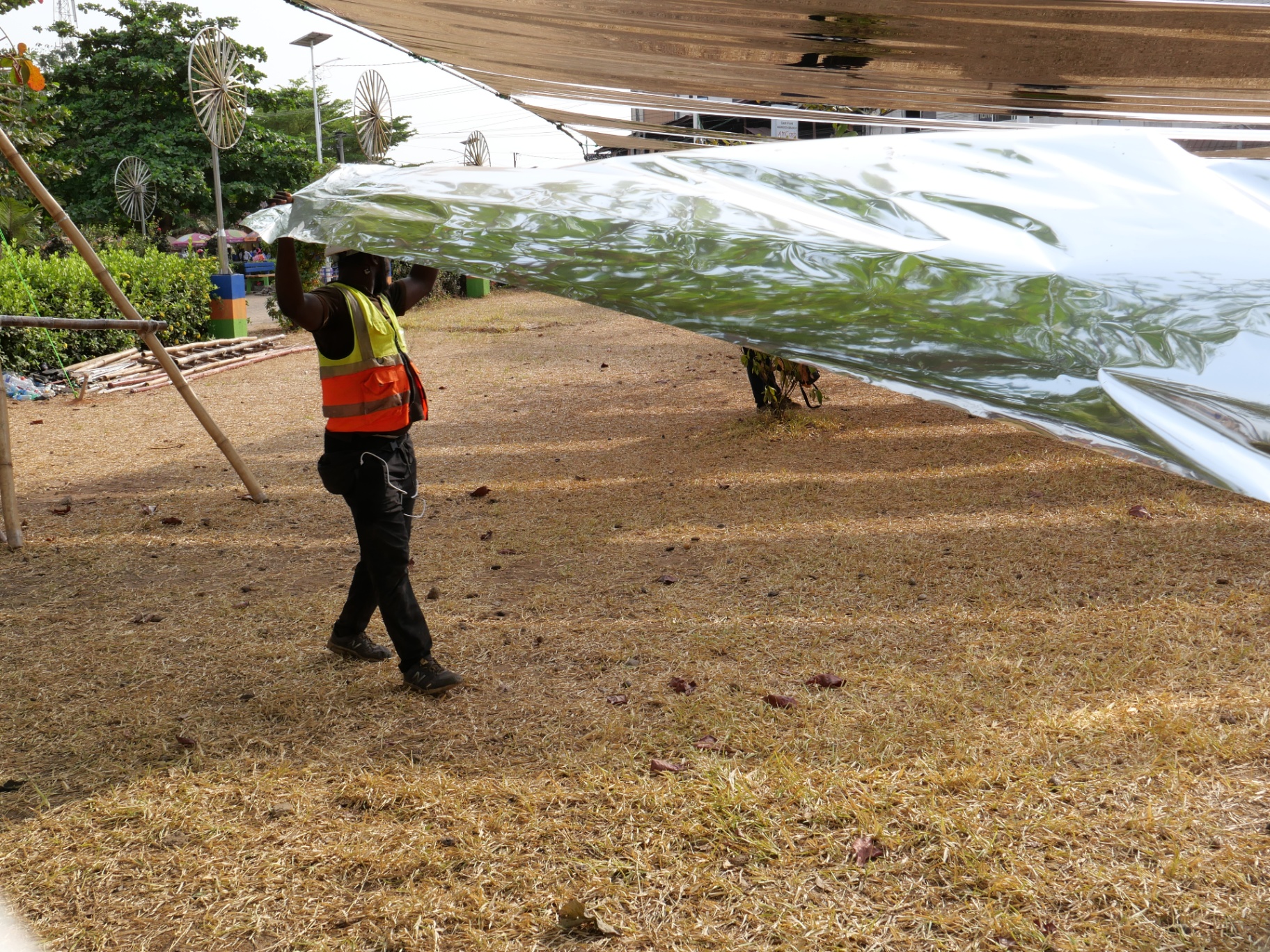 Carrying a length of reflective sheeting under a canopy