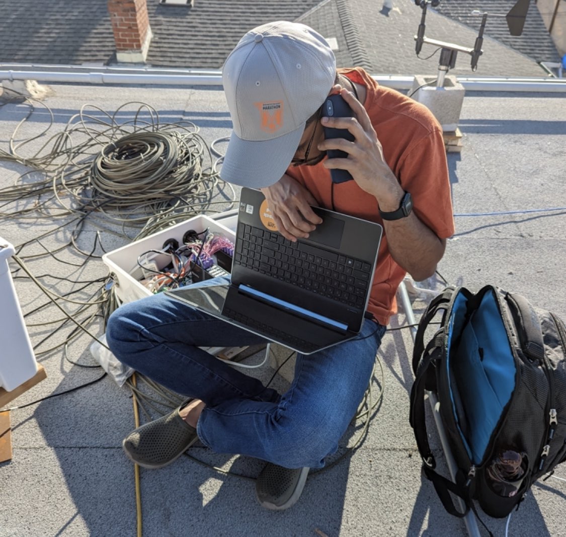 Researcher configuring rooftop instrumentation in California