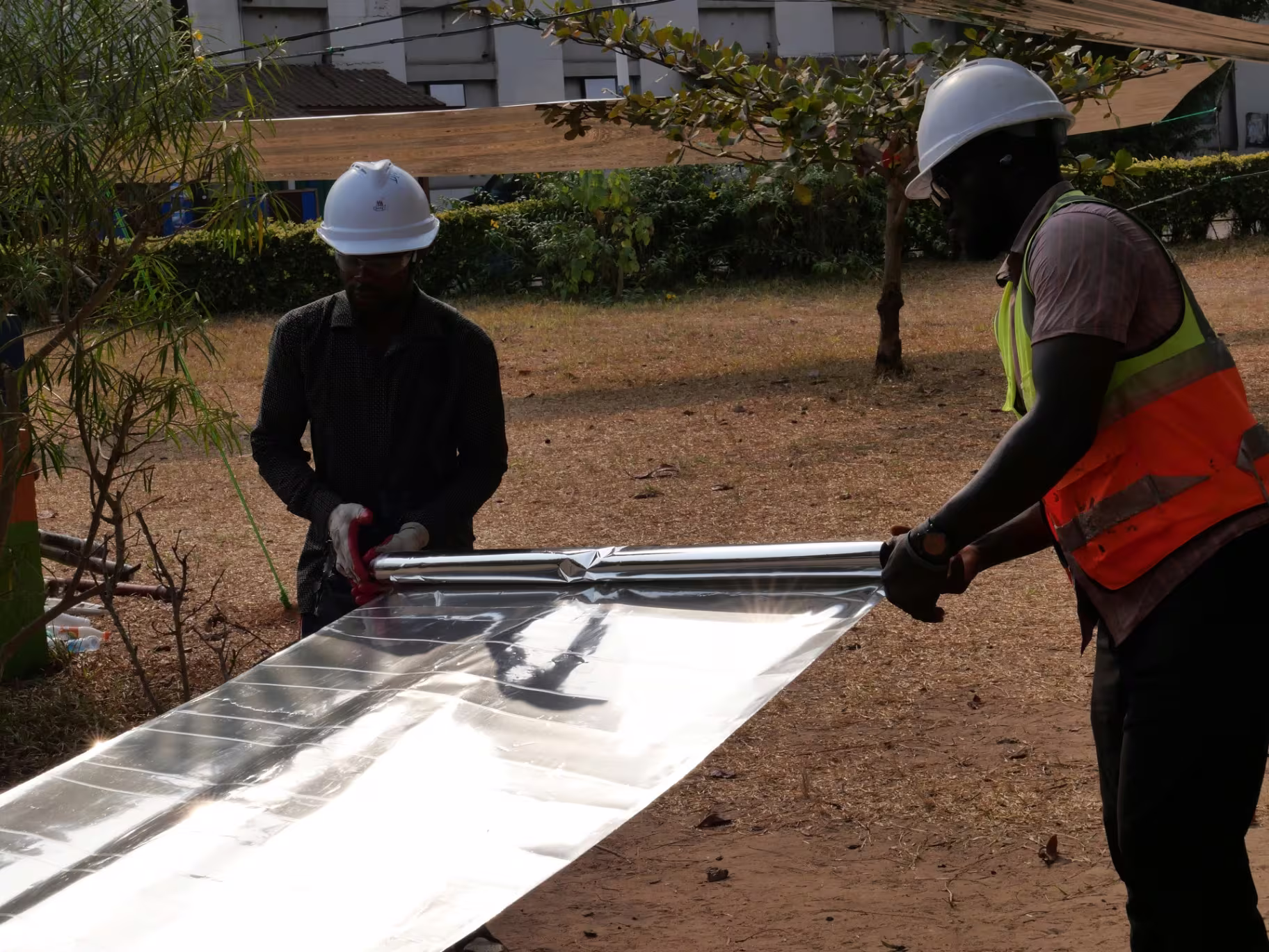 The local install team fitting sheeting to an existing roof.