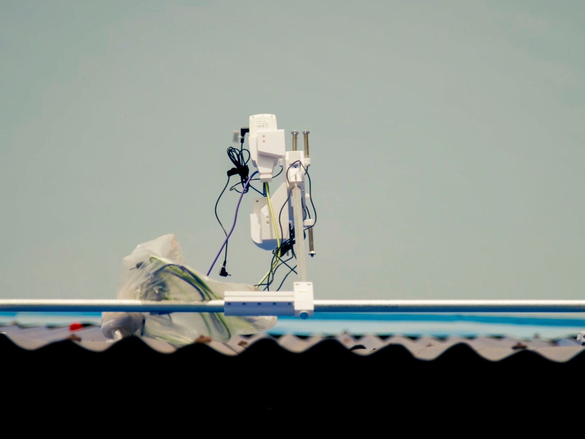 Rooftop environmental sensor above a reflective roof